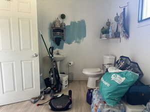 Bathroom featuring toilet and hardwood / wood-style flooring