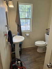 Bathroom #2 Upstairs Building #2 with toilet and hardwood / wood-style flooring