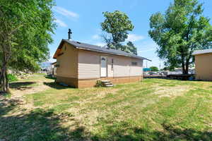 Back of house featuring a lawn