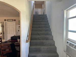 Stairway with a textured ceiling and cooling unit