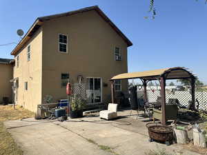 Back of property with a fire pit and a patio