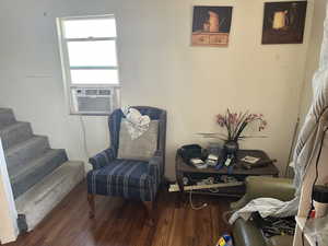 Sitting room featuring cooling unit and dark hardwood / wood-style floors