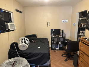 Bedroom #2 Building #2 Downstairs featuring light parquet flooring and a textured ceiling