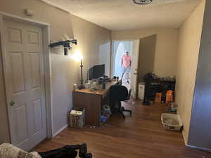 Other view Bedroom #2 upstairs Building #2 with a textured ceiling and hardwood / wood-style flooring