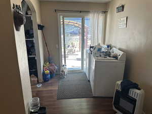 Building #2 Laundry area featuring dark hardwood / wood-style flooring, heating unit, and washing machine and dryer