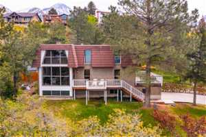 Rear view of property featuring a deck with mountain view