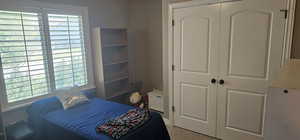 Carpeted bedroom featuring a closet and a textured ceiling