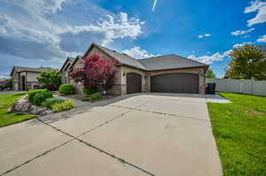 View of front of property featuring a garage and a front yard