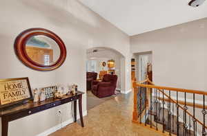 Corridor featuring tile floors and lofted ceiling