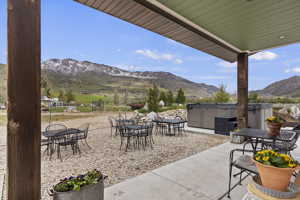 Covered rear patio with a mountain view and Swim Spa