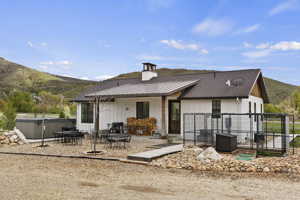 Rear view of house featuring a patio area, a mountain view, and Large Swim Spa