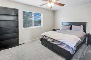 Bedroom with ceiling fan and carpet flooring