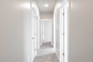 Hallway with light colored carpet