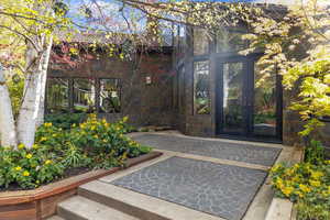 Doorway to property featuring a patio area