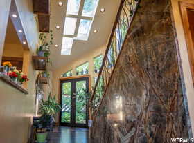 Entrance foyer featuring a high ceiling, french doors, and dark wood-type flooring