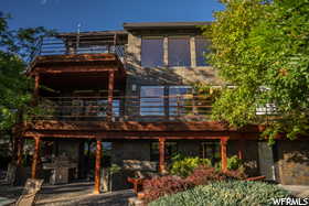 Rear view of house featuring a pergola