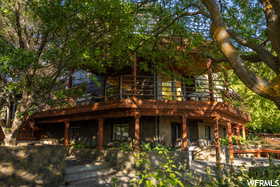 View of front of home featuring a wooden deck