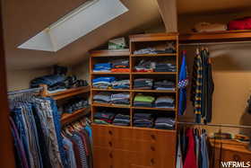 Spacious closet featuring vaulted ceiling