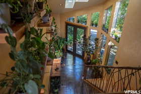 Foyer entrance featuring a skylight, french doors, and tile floors