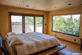 Bedroom featuring hardwood / wood-style floors and access to exterior