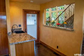 Interior space featuring sink and light stone countertops