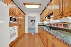 Kitchen directly between Formal & Semi-Formal Dining Rooms