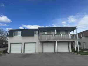 View of front property with a balcony and a garage