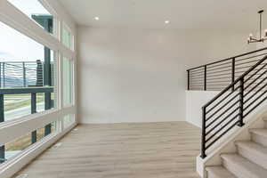 Interior space featuring light hardwood / wood-style floors, a wealth of natural light, and a chandelier