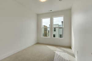 Spare room with light colored carpet