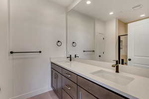 Bathroom with tile patterned floors and vanity