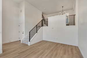 Interior space with light hardwood / wood-style flooring and a notable chandelier