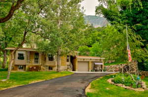 View of front of house featuring a garage, a front yard, and a mountain view