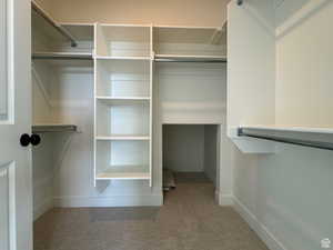 Walk in closet featuring carpet