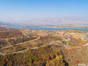 Birds eye view of property with a water and mountain view