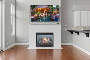 Unfurnished living room featuring a wealth of natural light and wood-type flooring