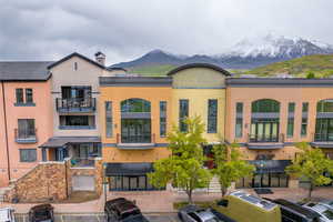 View of front of property with a mountain view and a balcony