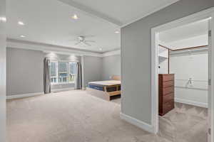 Bedroom featuring light carpet, crown molding, and ceiling fan