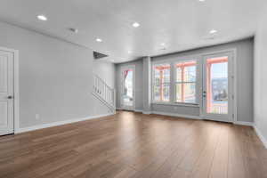 Spare room with hardwood / wood-style flooring and a textured ceiling