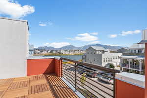 Balcony featuring a water and mountain view