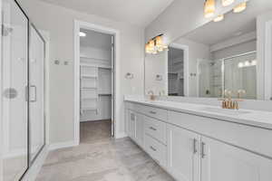 Bathroom with a shower with door and vanity