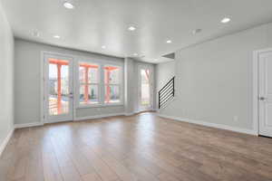 Empty room featuring light hardwood / wood-style floors and a textured ceiling