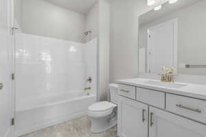 Full bathroom with washtub / shower combination, vanity, and toilet