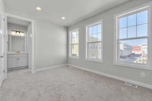 Carpeted spare room with sink