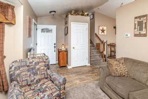 Living room featuring hardwood / wood-style flooring and lofted ceiling