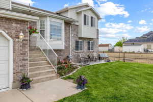 Exterior space with a patio, a yard, and solar panels