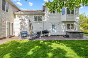 Rear view of property featuring a patio and a yard