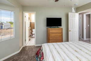Bedroom featuring carpet, connected bathroom, and ceiling fan
