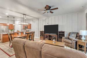 Living room featuring light wood-type flooring and ceiling fan