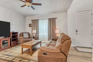 Living room featuring light wood-type flooring and ceiling fan