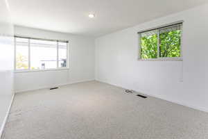 Spare room/bedroom with a wealth of natural light